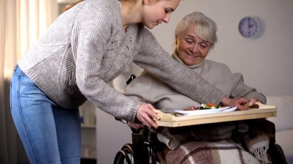 Adult physical disability support for an old woman at home. Domiciliary care at home, Woking.